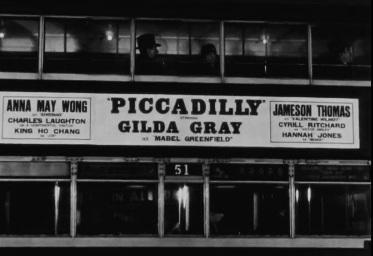 Frame from the credits from 1929 film Piccadilly, showing the side of double-decker London bus listing the principle cast