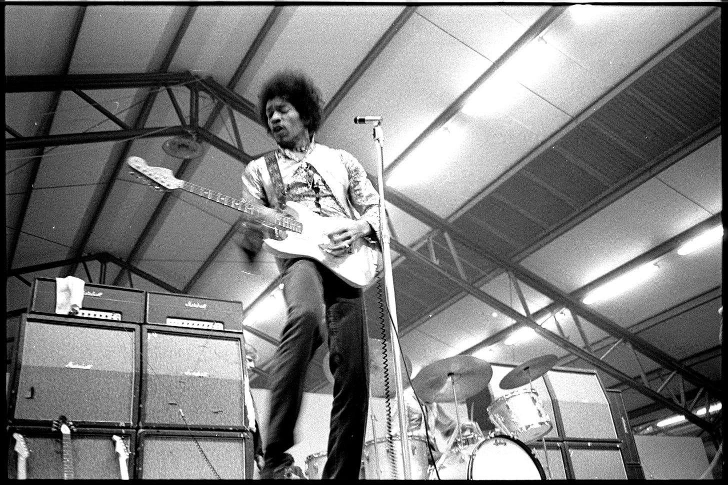 Jimi Hendrix plays live onstage