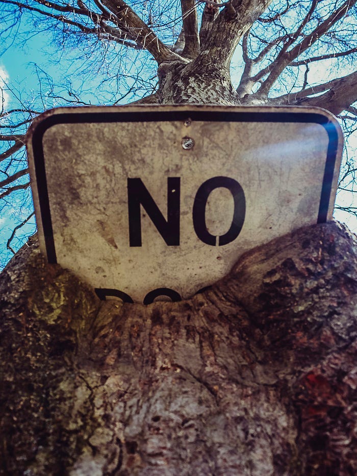 The alphabet “NO” on a white board, stuck in mud.