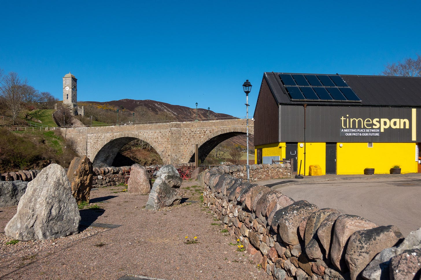 Geology trail outside Timespan museum, art gallery and café in Helmsdale, with the Old Bridge and war memorial Clocktower in the background © Felicity Martin Geology trail outside Timespan museum, art gallery and café in Helmsdale, with the Old Bridge and war memorial Clocktower in the background © Felicity Martin