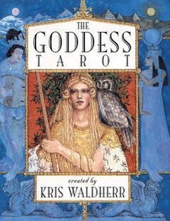 The cover of a tarot deck featuring a woman holding a stave with an owl on her shoulder