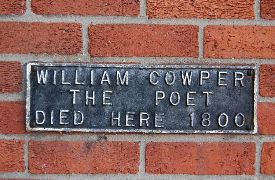 Metal sign on brick: WILLIAM COWPER THE POET DIED HERE 1800