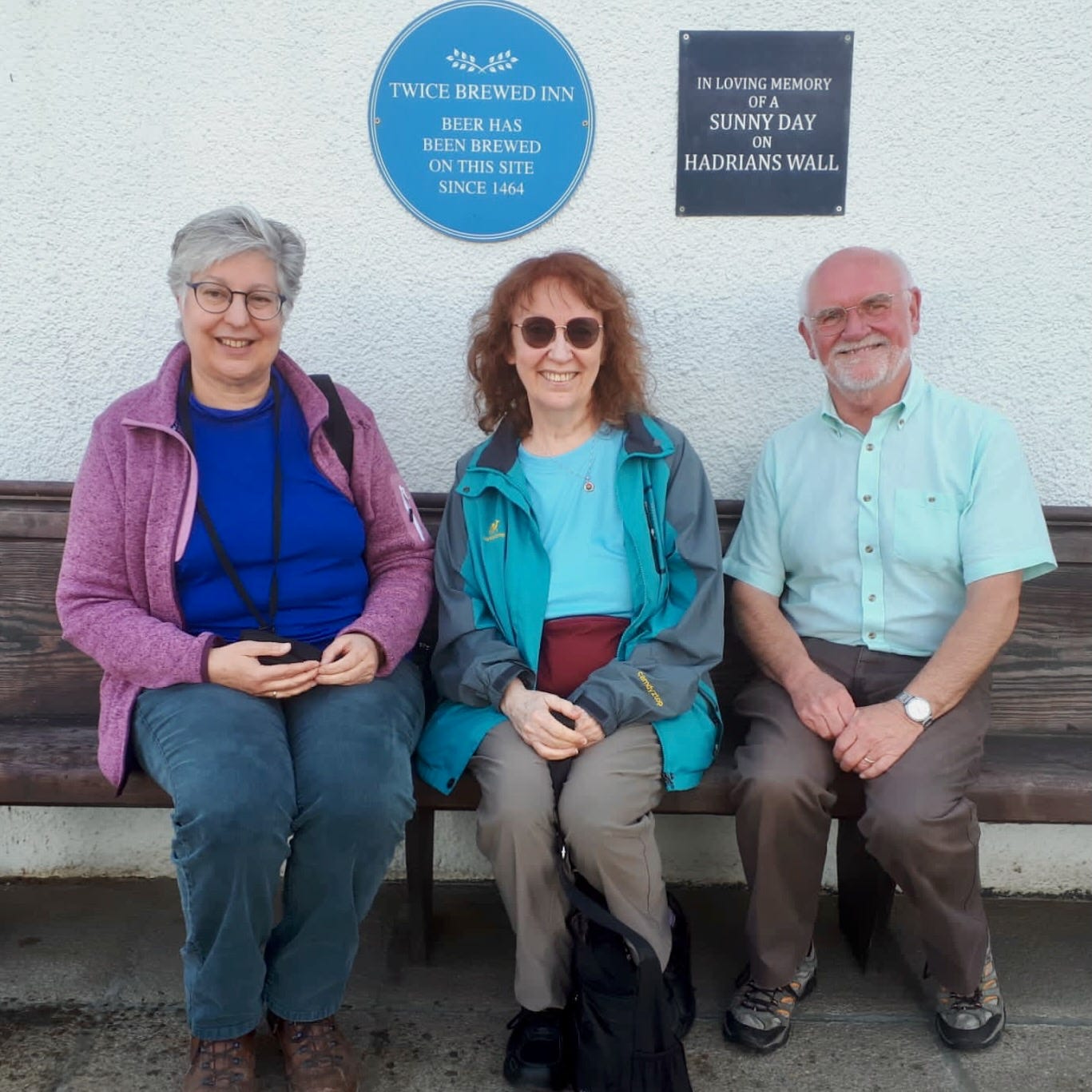 Three people smiling at the camera