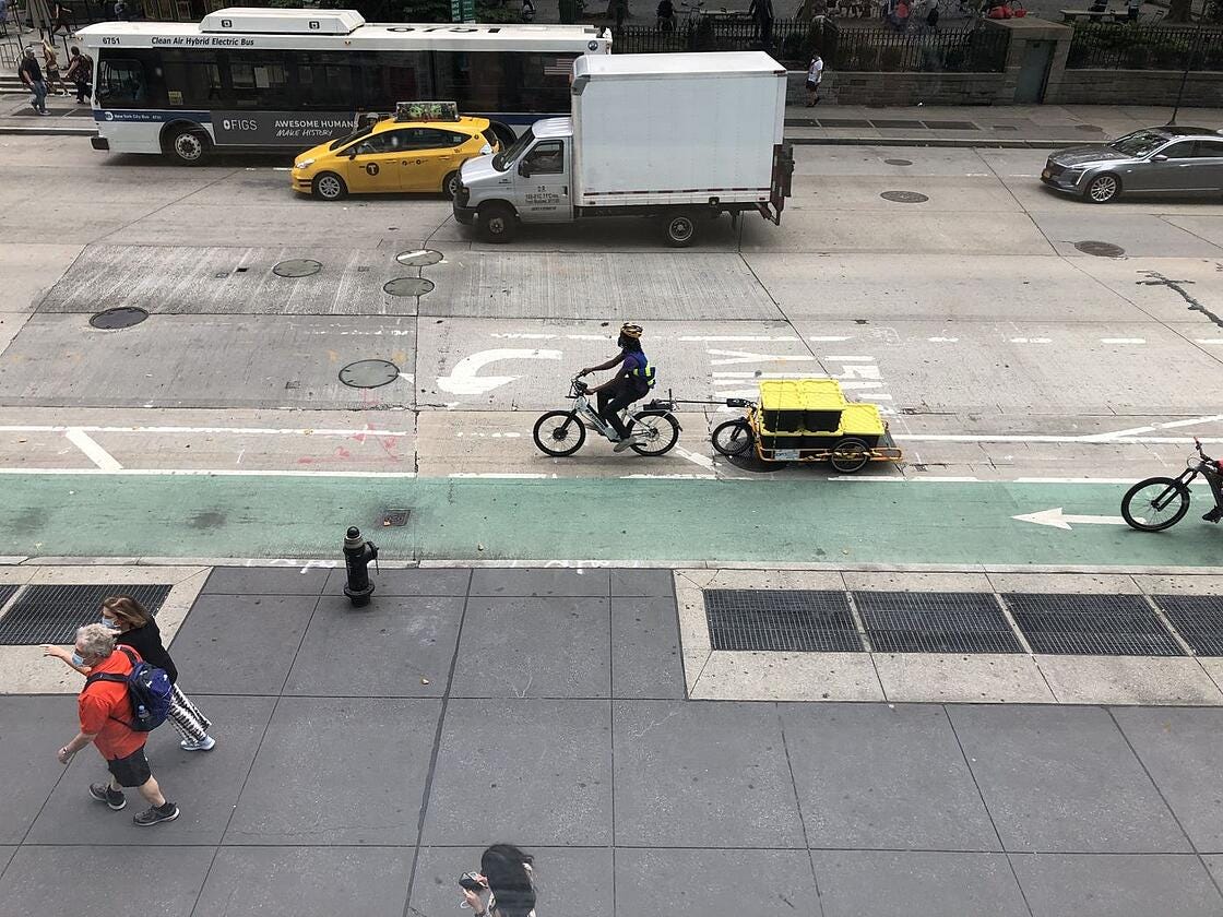 Man cycling outside of a bike lane in New York City