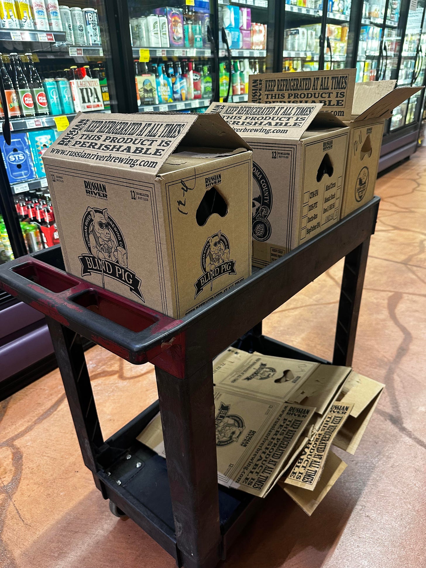 a Whole Foods cart with boxes of Russian River Beer