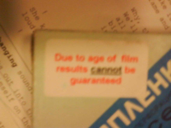 Super 8 film package with sticker reading "due to age of film results cannot be guaranteed."