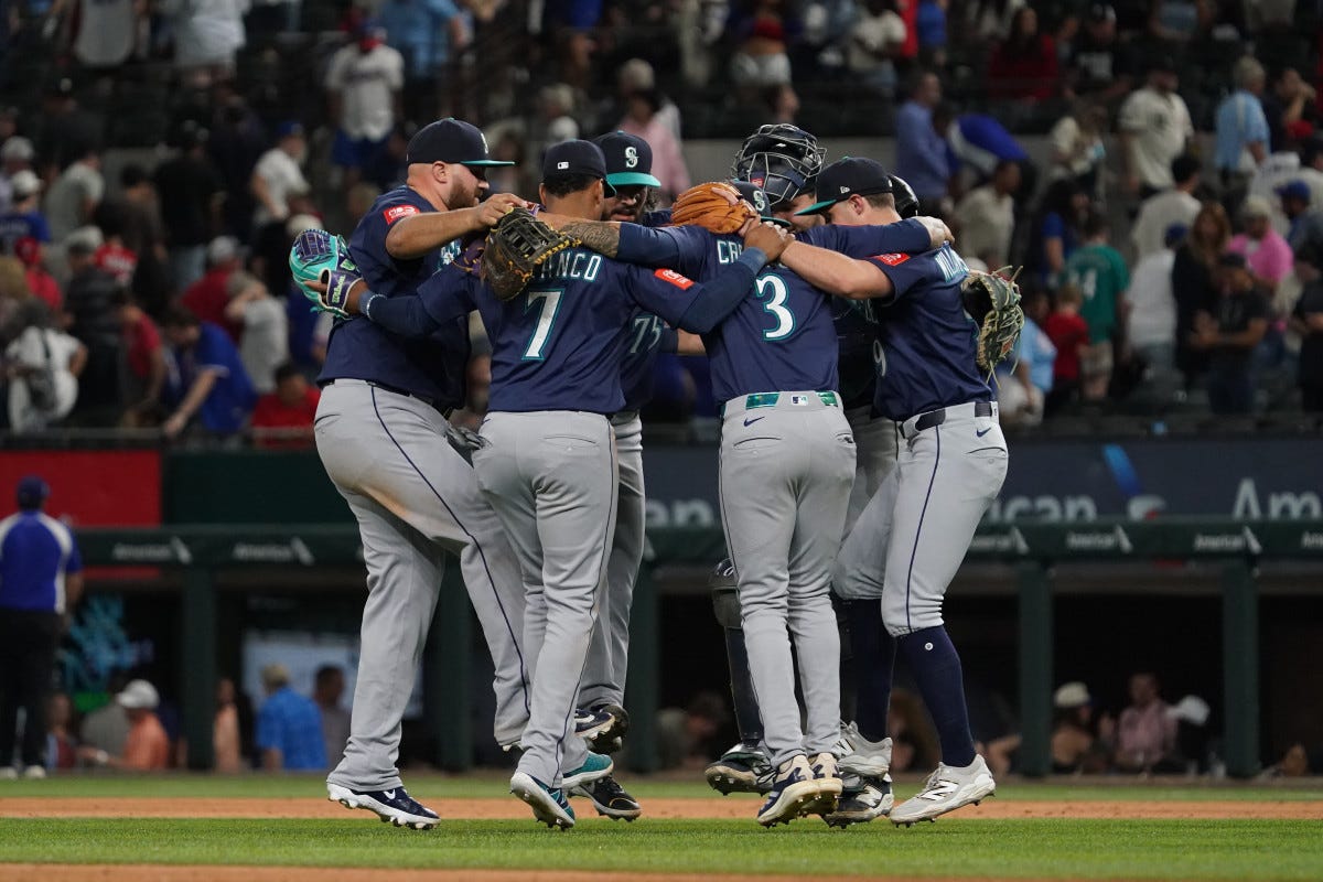 May 3, 2025; Arlington, Texas, USA; The Seattle Mariners do a circle dance to celebrate their victory against the Texas Rangers at Globe Life Field. Mandatory Credit: Raymond Carlin III-Imagn Images