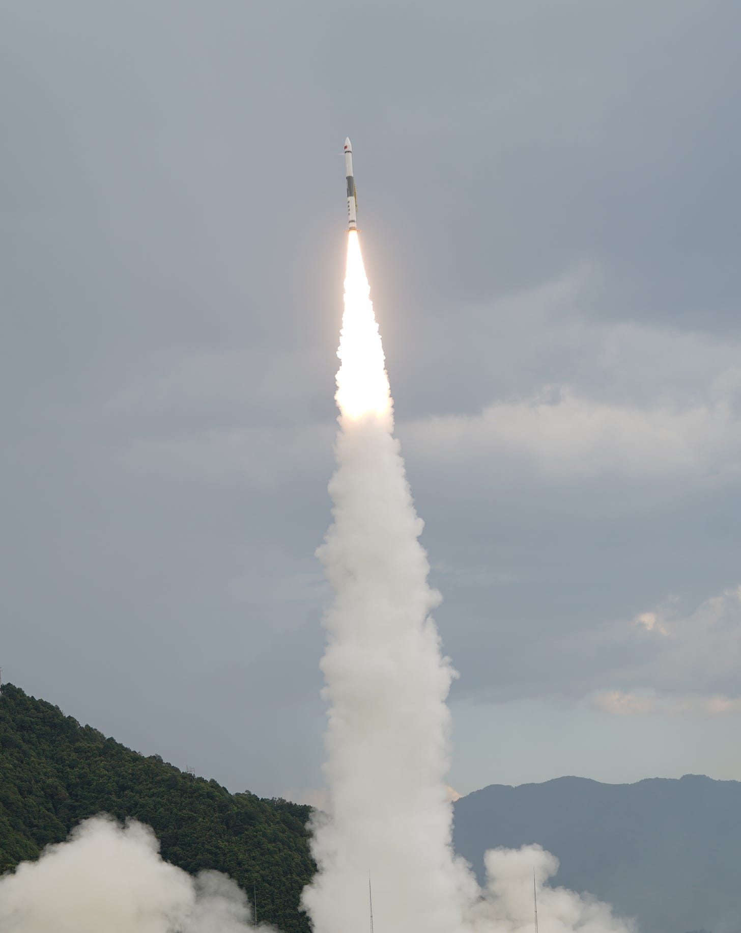 Kuaizhou-1A lifting off from Xichang while firing one of its attitude control thrusters.