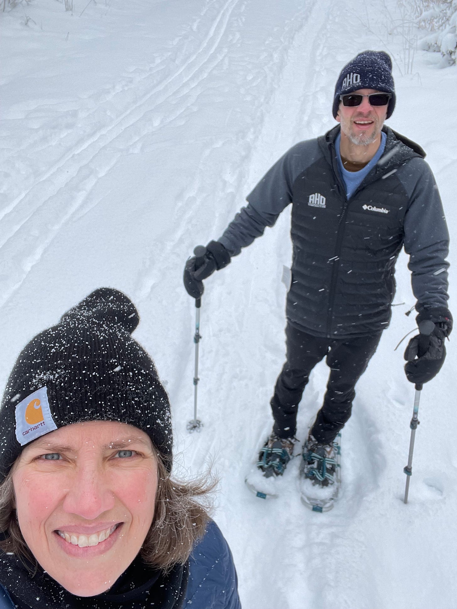 A woman and man on snowshoes in deep snow