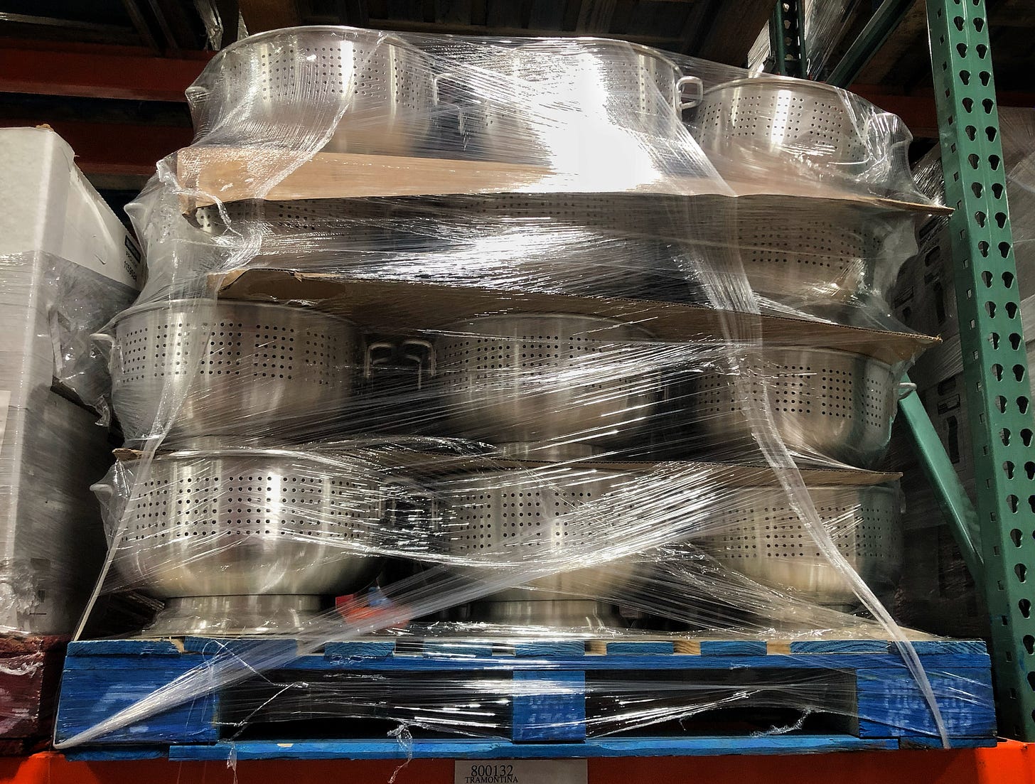 A pallet of very large, shrink-wrapped colanders on a high shelf at the Costco Business Centre