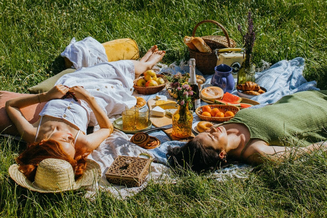 Free Women Lying on Green Grass Field Stock Photo