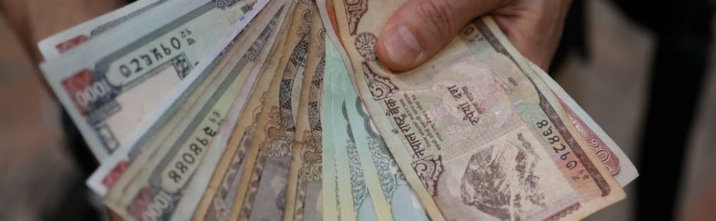 Free A close-up of hands holding a fan of Nepalese rupee banknotes showcasing various denominations. Stock Photo Free A close-up of hands holding a fan of Nepalese rupee banknotes showcasing various denominations. Stock Photo