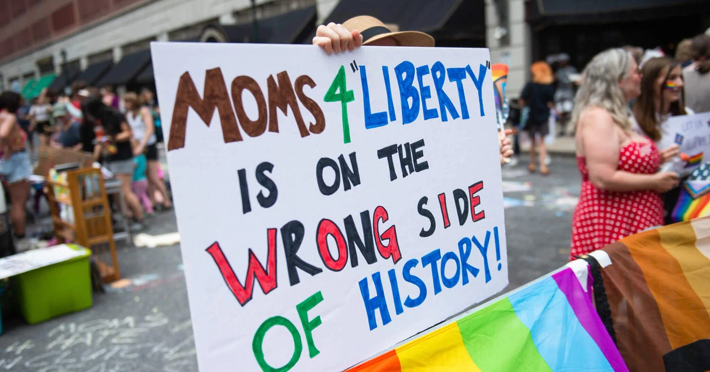 A protester outside the Moms for Liberty Summit