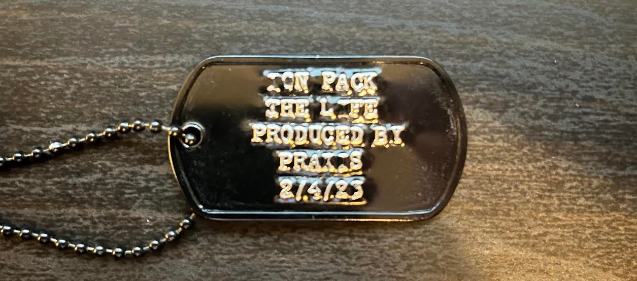 Dog tag that reads "Ion Pack : The Life : Produced by Praxis : 2/4/23"