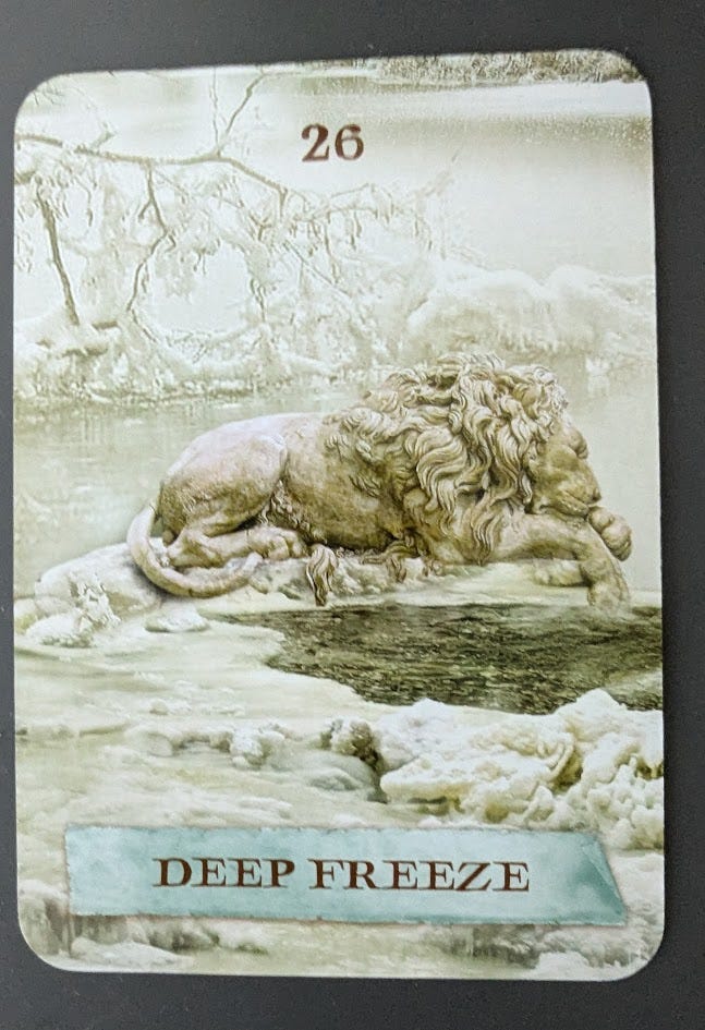 A card from the Enchanted Map Oracle Deck. It's the Deep Freeze card, and the image is a lion (or perhaps a lion statue) sleeping in a frozen landscape.