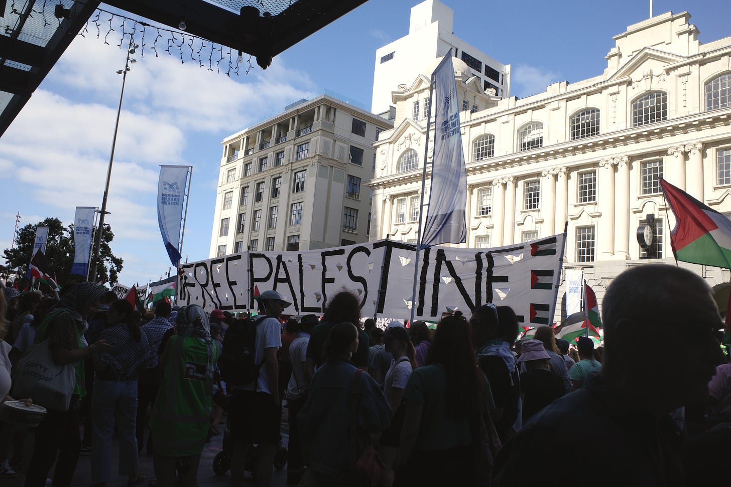 A Palestine protest march with an extra large "Free Palestine" banner