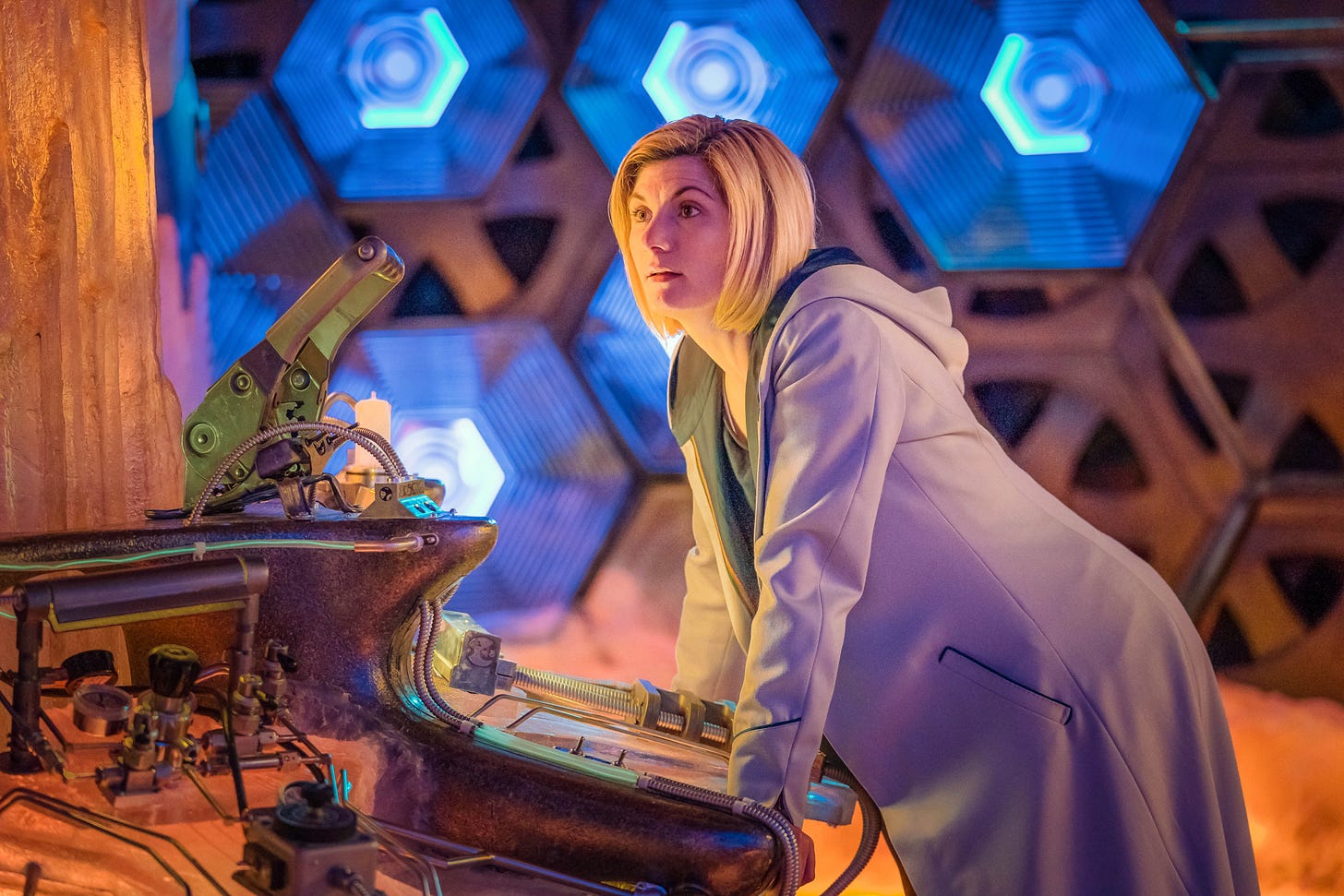 This image shows the Thirteenth Doctor (played by Jodie Whittaker) leaning with both palms flat on her TARDIS's central console in "The Battle of Ranskoor Av Kolos" (Doctor Who Series 11's tenth episode and season finale). This image shows the Thirteenth Doctor (played by Jodie Whittaker) leaning with both palms flat on her TARDIS's central console in "The Battle of Ranskoor Av Kolos" (Doctor Who Series 11's tenth episode and season finale).