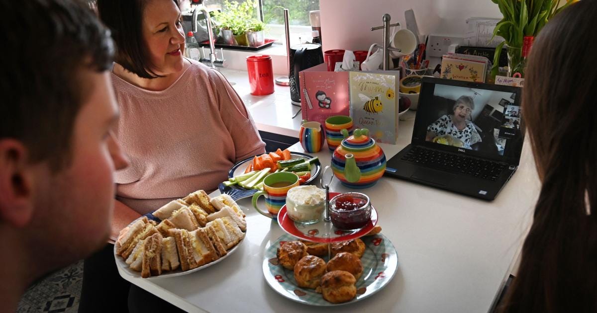 a family having a video call with an elderly family member