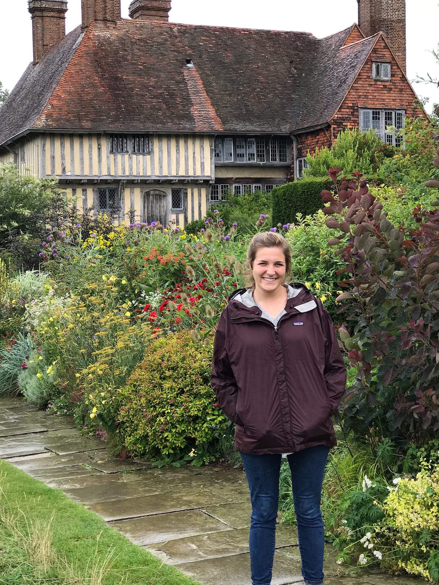 Molly in front of the Long Border at Great Dixter. Photo via Molly Hendry