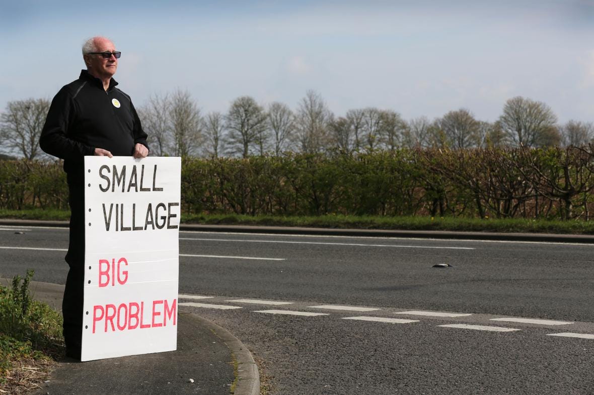 A protester stands outside RAF Scampton in Lincolnshire. The Home Office has failed to find people to survey the buildings it wants to use