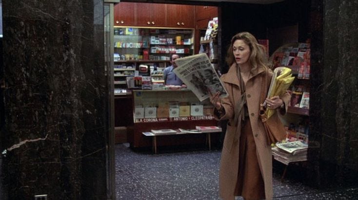 This may contain: a woman in a trench coat is holding a newspaper and looking at the camera while standing in front of a book store