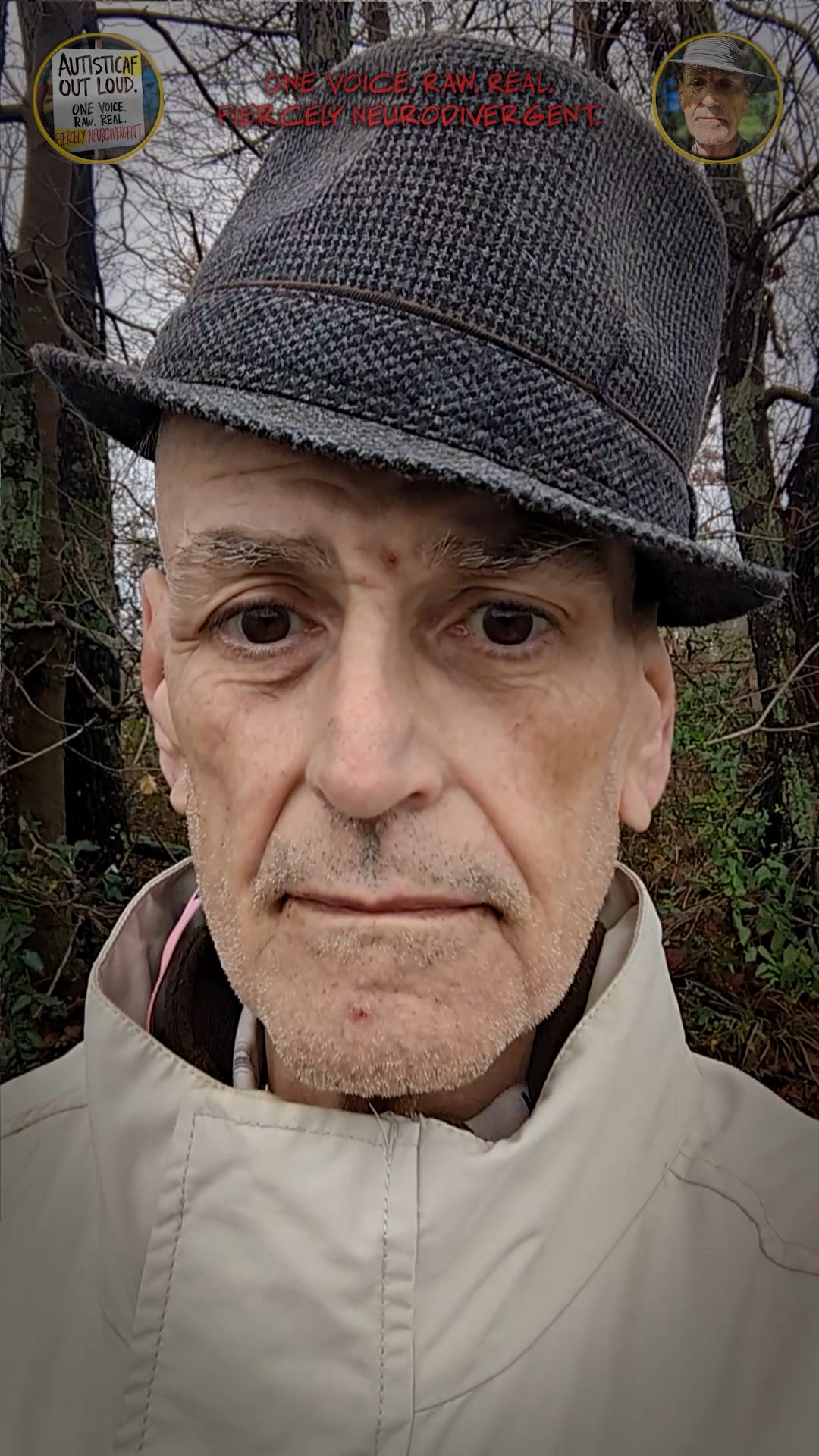 Selfie of the author in a country setting, framed by trees, wearing a fedora and overcoat.