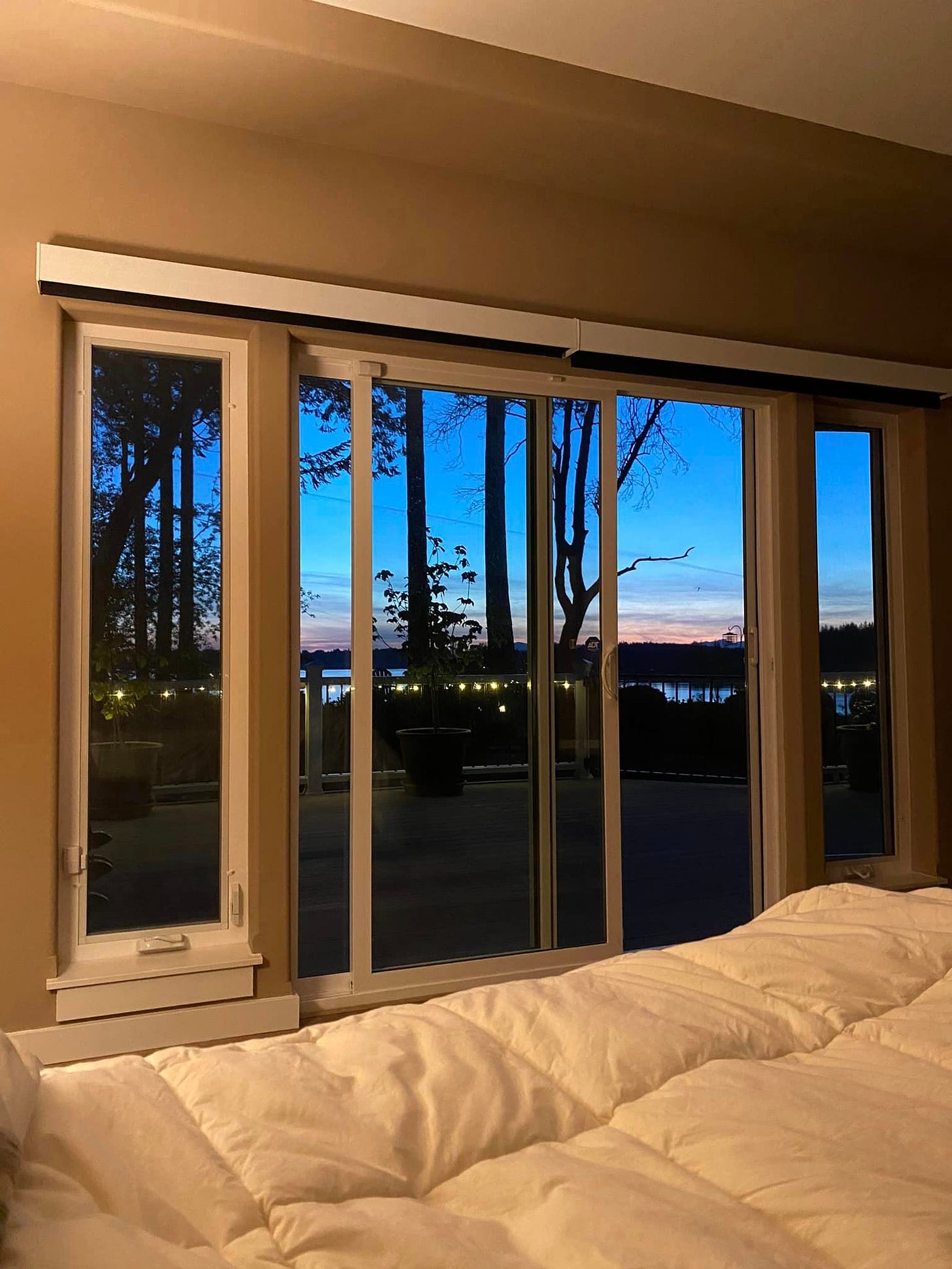May be an image of bedroom, twilight, indoors and sliding door