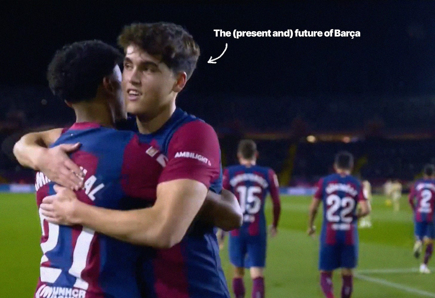 A screenshot of Pau Cubarsí hugging Lamine Yamal with Barcelona players in the background.