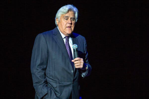 Jay Leno on stage performing a routine. 