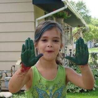 beautiful little girl holding up her mud covered hands indicating quick and dirty grammar tips