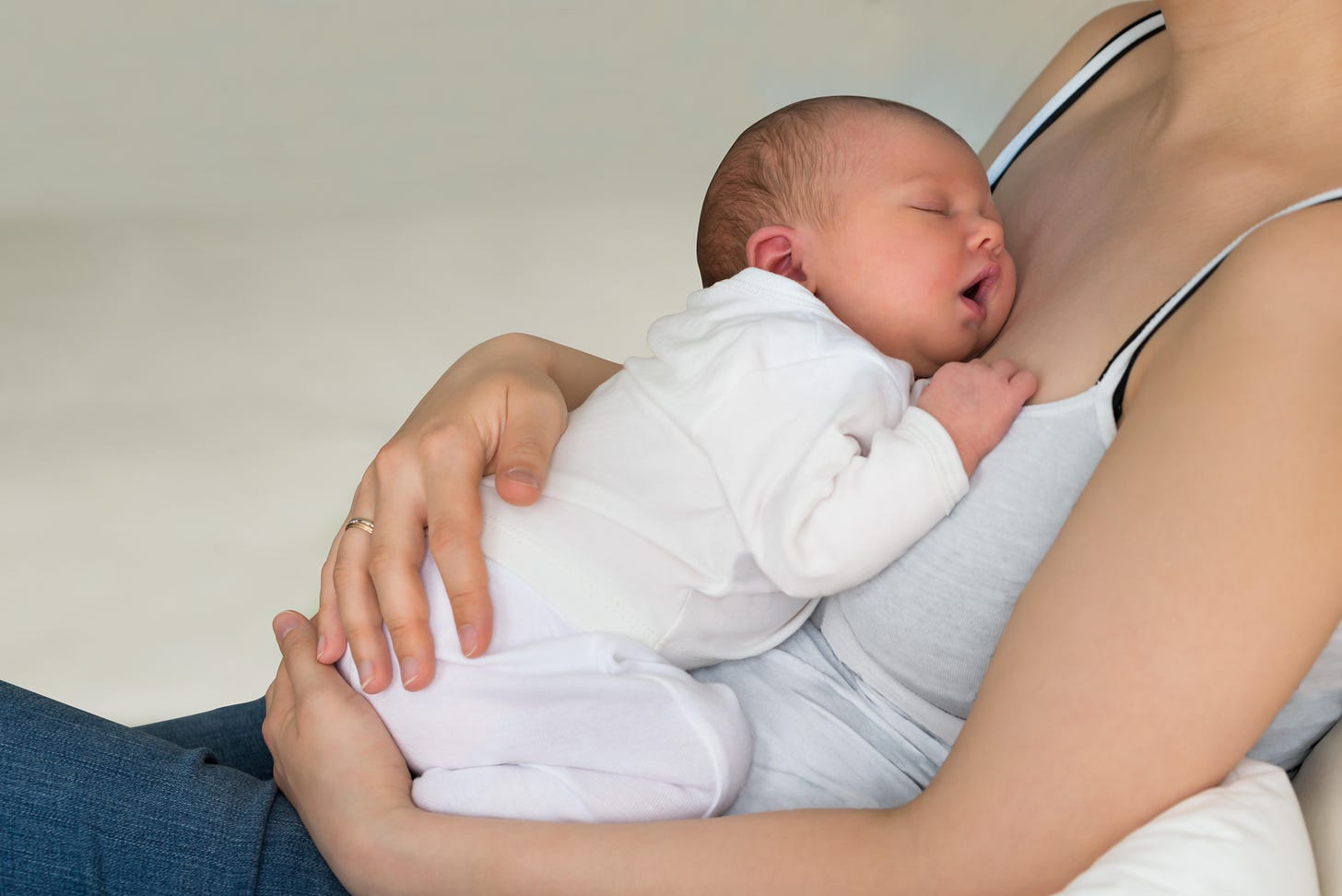 Close-up of a mother holding a sleeping baby