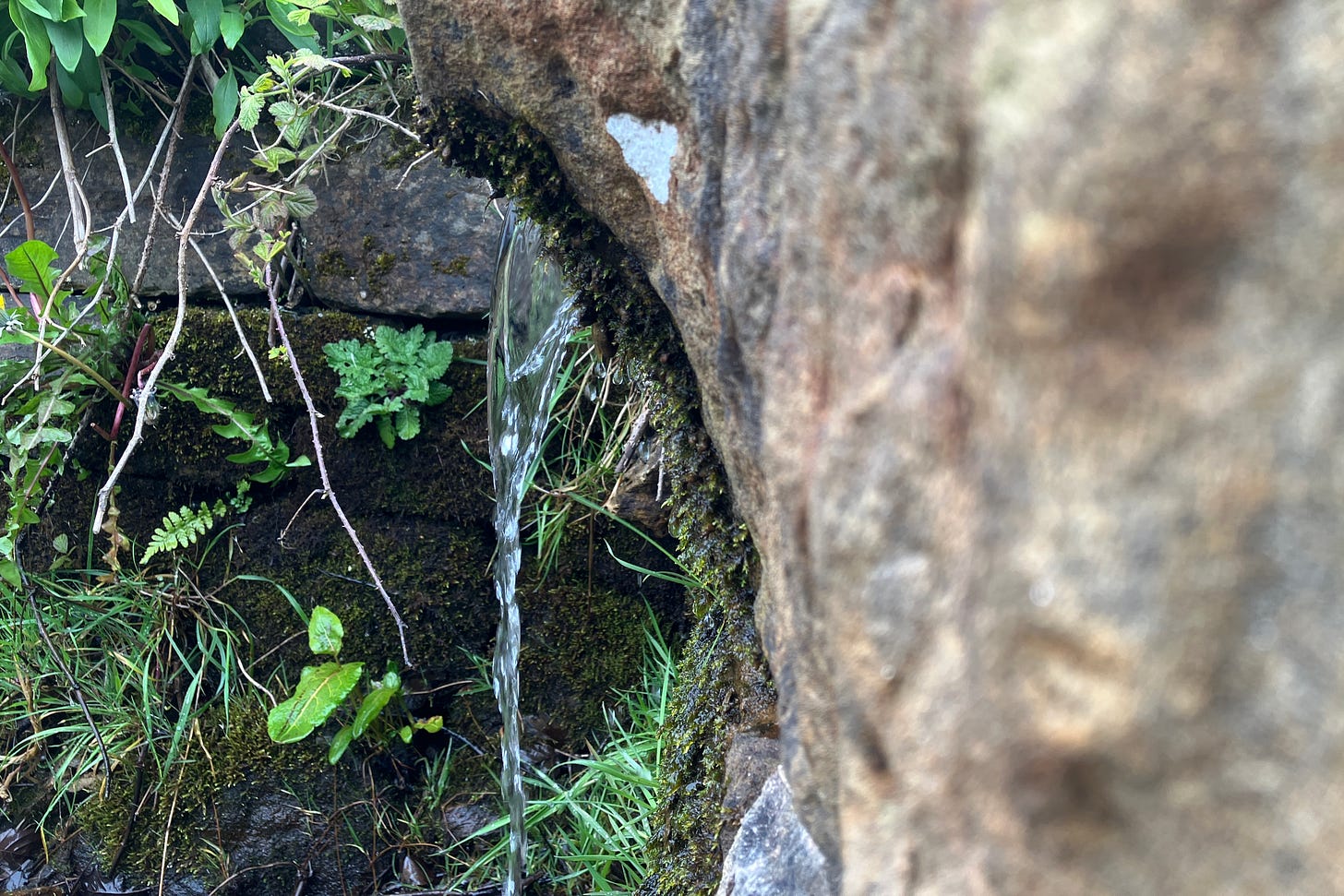 Water trickles from stone trough