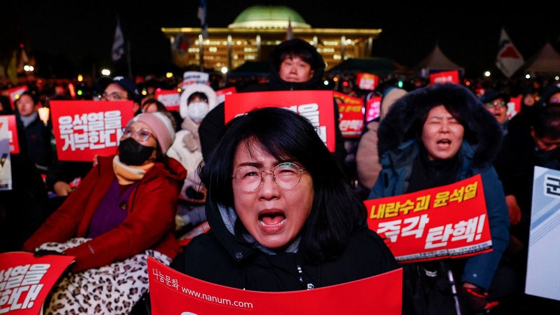 A protestor holds a placard during a rally calling for the impeachment of South Korean President Yoon Suk Yeol, in front of the National Assembly in Seoul, South Korea, on December 7.