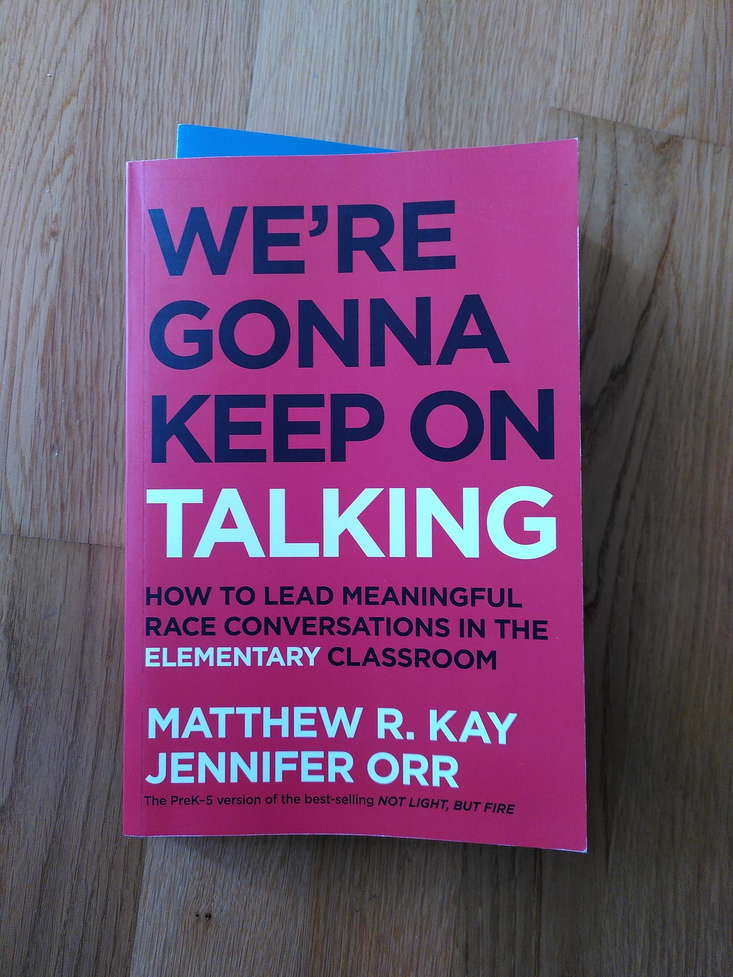 book cover, red background with Black bold all caps: We're Gonna Keep On (in white) Talking: How to lead meaningful race conversations in the elementary classroom. Matthew R. Kay and Jennifer Orr