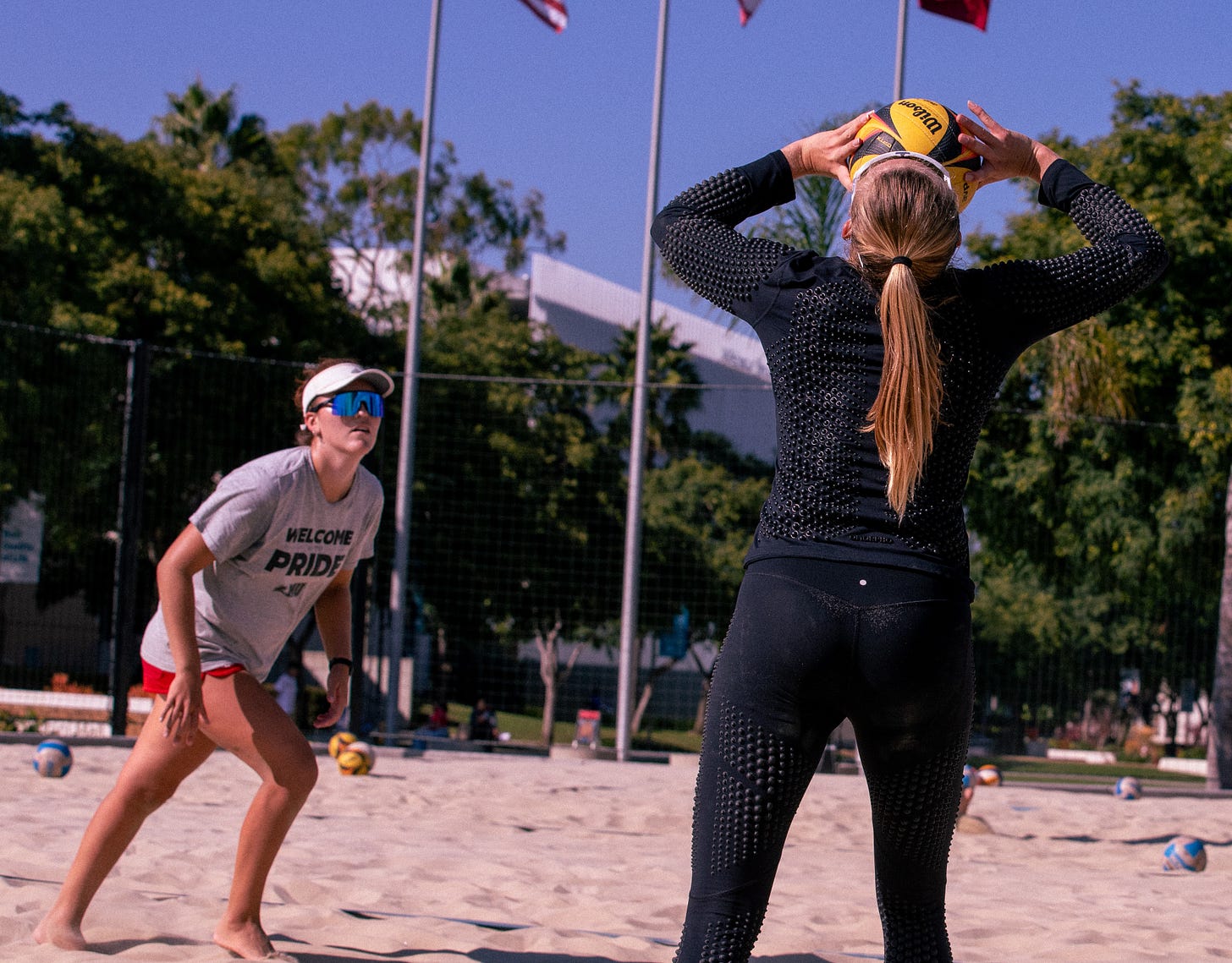 beach volleyball player setting her partner
