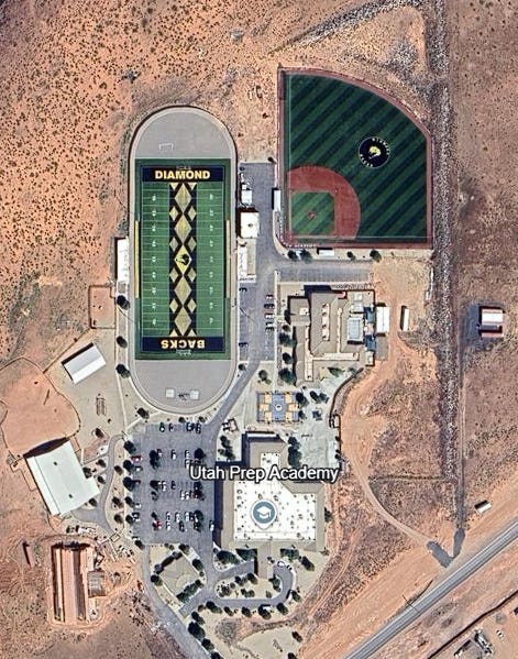 A satellite photo of a campus in the desert, showing a football field and baseball diamond, labeled "Utah Prep Academy"