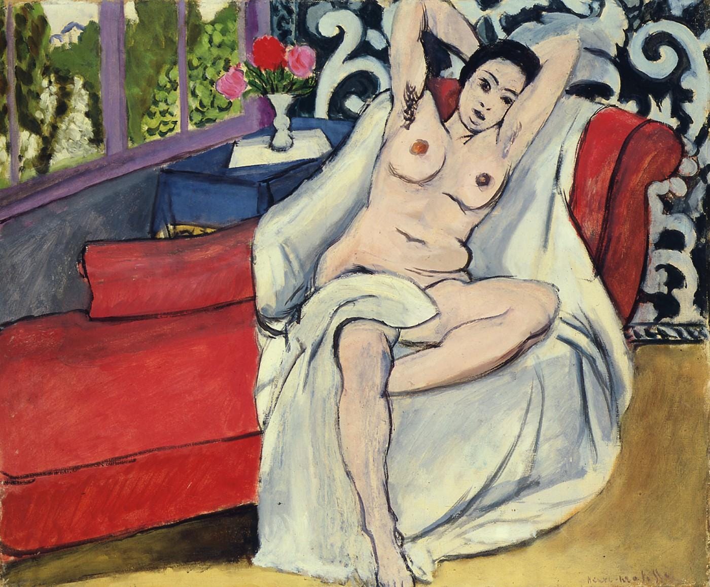A Matisse painting of a nude on a red sofa