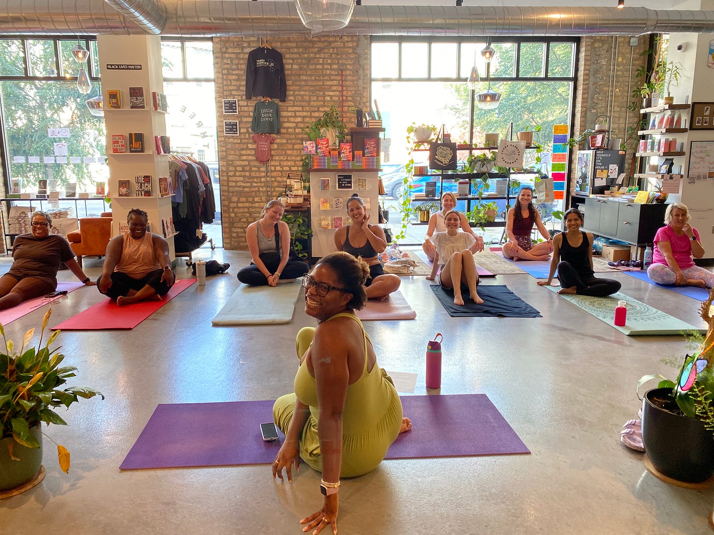 A picture of women doing yoga inside of a bookstore