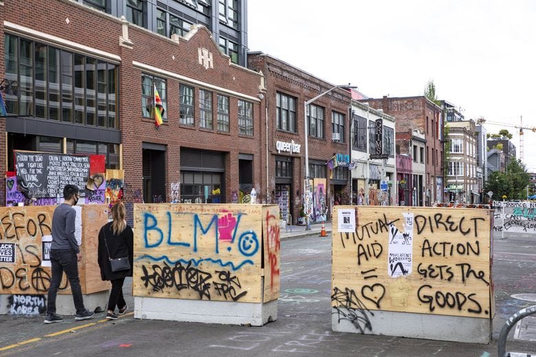 The city of Seattle has settled a lawsuit filed by more than a dozen businesses, led by Seattle developer Hunters Capital, all located in and around the eight-block area that became known as the Capitol Hill Organized Protest zone, or CHOP. (Bettina Hansen / The Seattle Times)