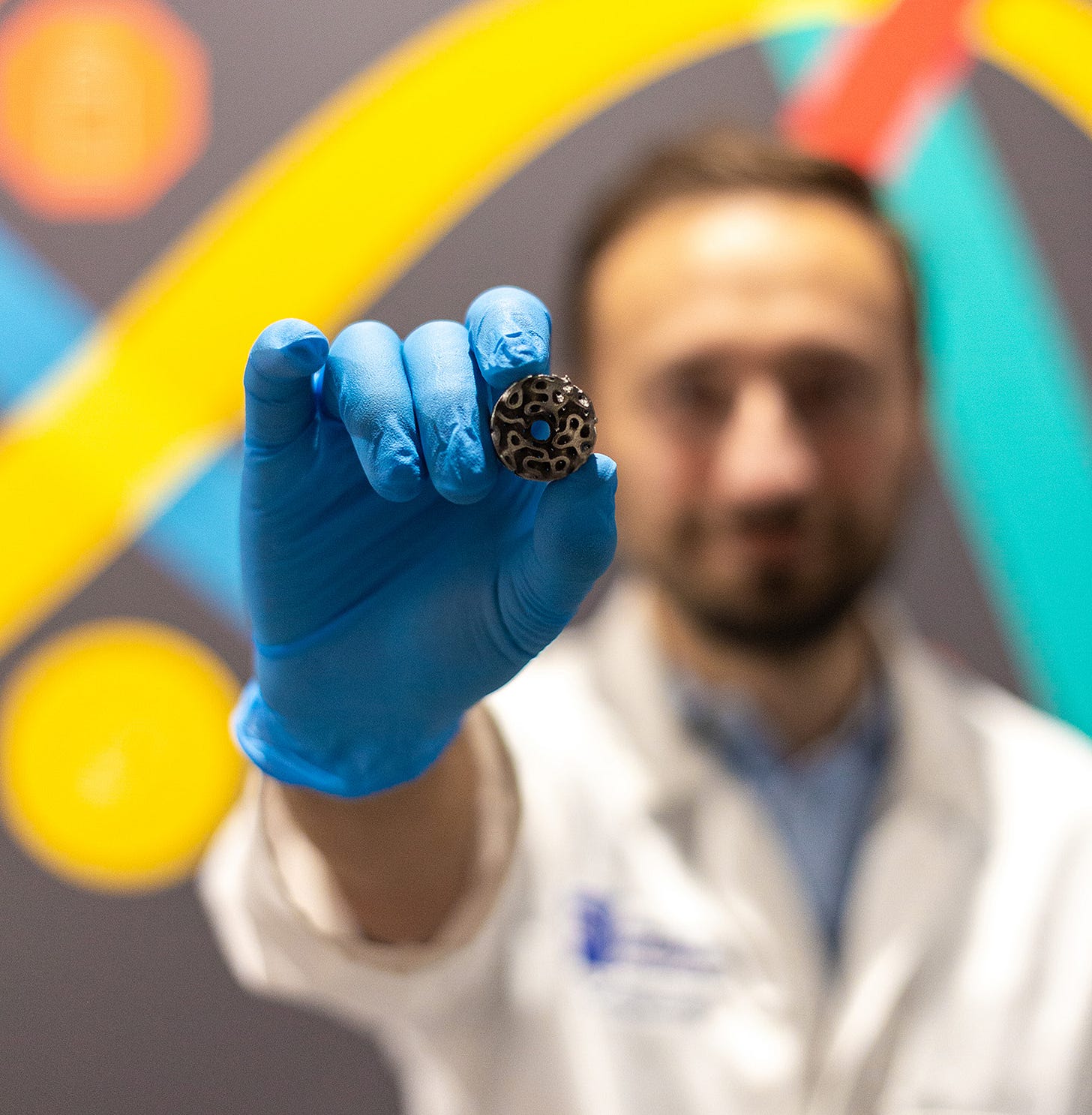 A person hold a small, round electrode