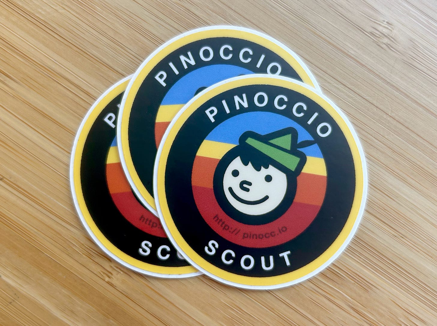 small stack of stickers that say Pinoccio Scout and have a cartoony Pinocchio character on them