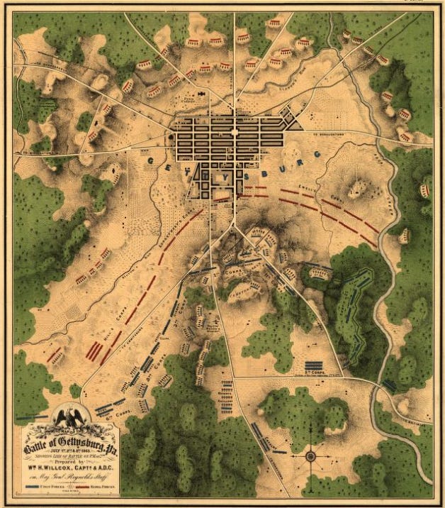 Battle of Gettysburg Map. It depicts Union forces in Blue and Confederate forces in Red. Both Armies are lived up for battle. The local roads and wooded areas are displayed in addition to unit locations.