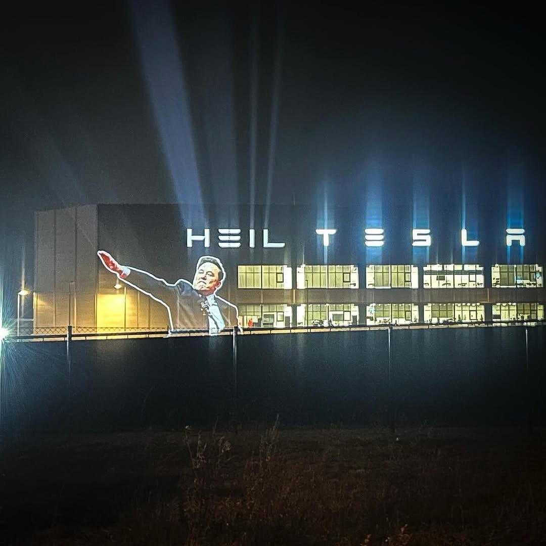 Photo of Elon Musk's Nazi salute projected on a Tesla facility in Germany