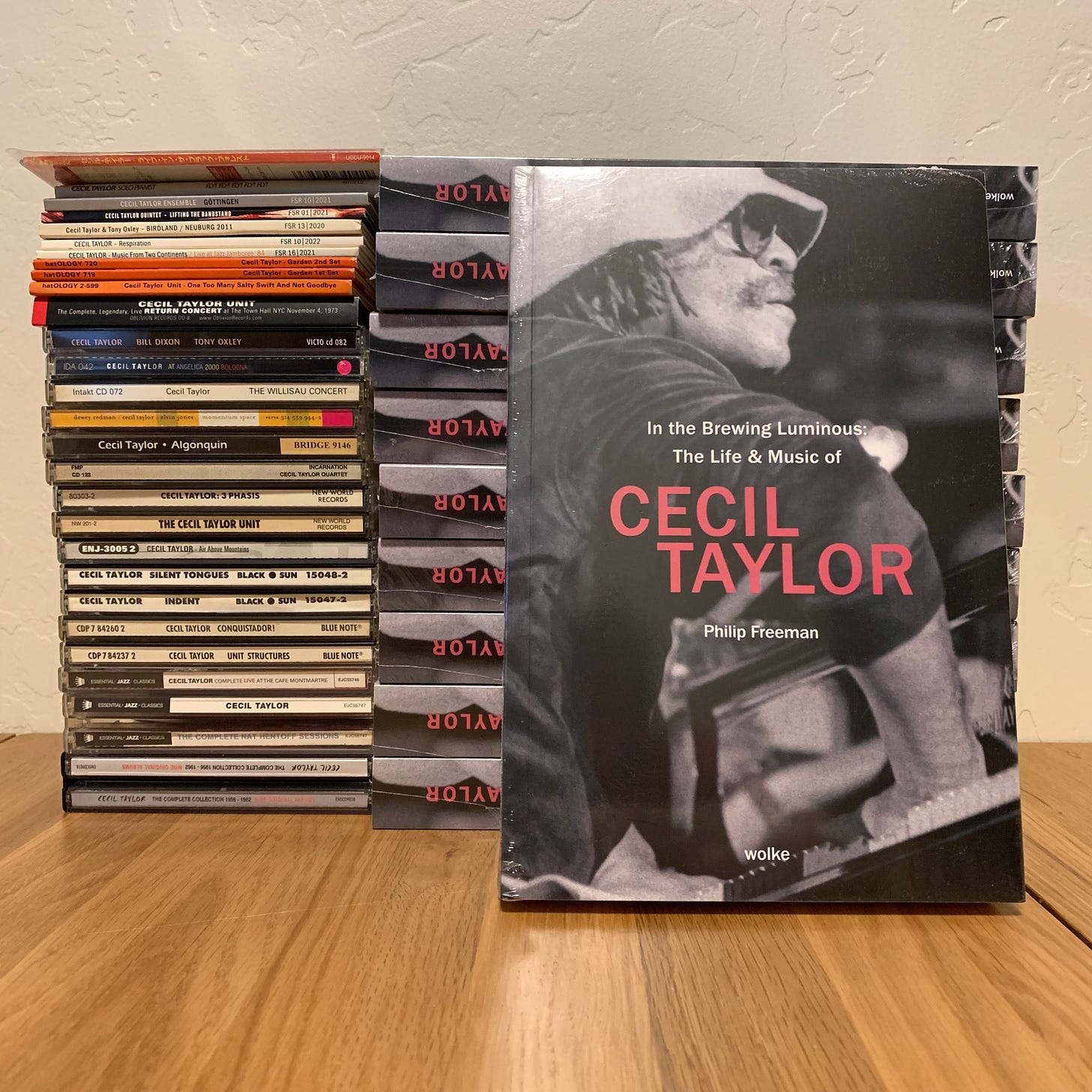 Copies of In The Brewing Luminous: The Life & Music of Cecil Taylor next to a stack of Taylor CDs