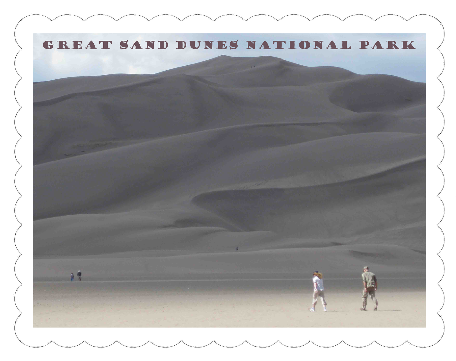 Great Sand Dunes National Park.  Photo of many layers of sand dunes with humans for scale in four different locations.  The people in the foreground are recognizable as a man and a woman.  The two near the top of the dune are a pair of black specks.