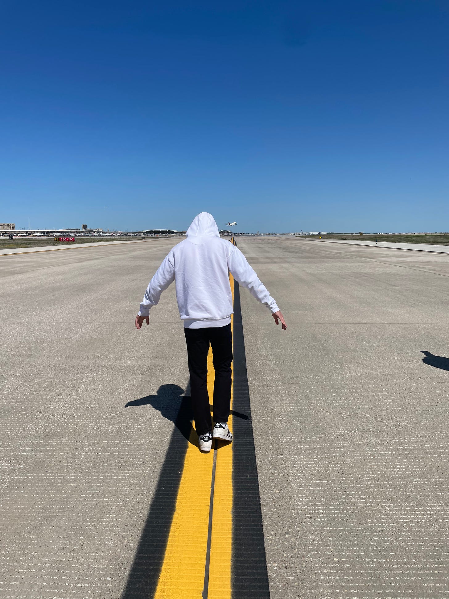 Person walking on taxiway at DFW airport