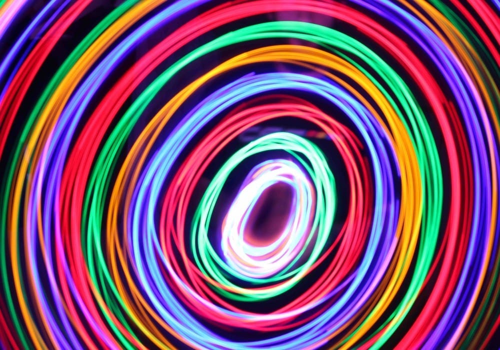 Neon circular rings representing layers of vibrational frequency