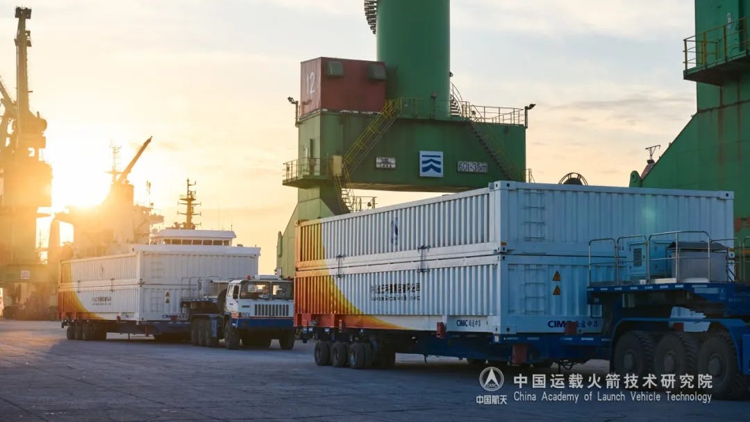 Two containers containing Long March 8A hardware after being unloaded and moved onto truck trailers.