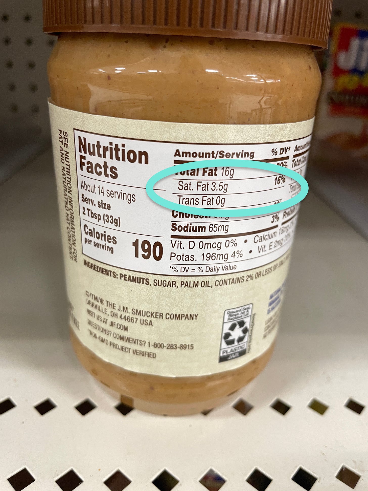 Peanut butter container highlighting saturated fat and trans fat