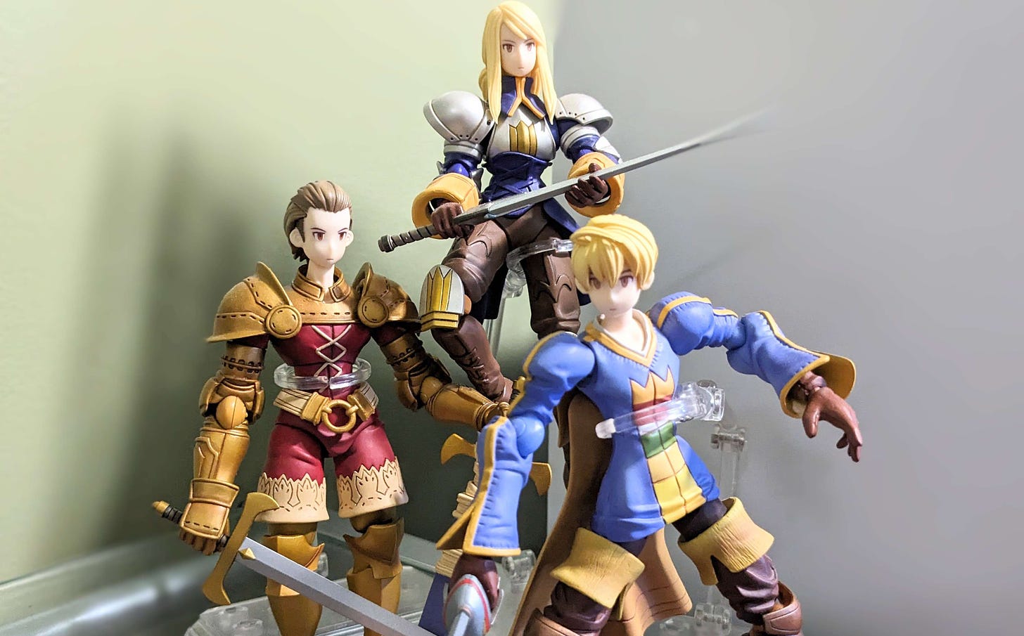 Plastic figurines of Ramza, Delita, and Agrias, from Final Fantasy Tactics.